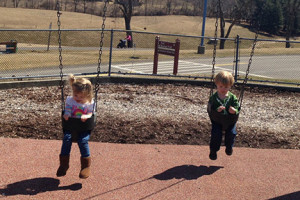 twins-swinging-playground
